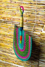 colorful bolga fan hanged on a bamboo blind