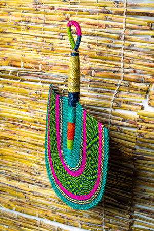 
                  
                    colorful bolga fan hanged on a bamboo blind
                  
                