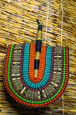 colorful bolga fan hanging on a bamboo blinds