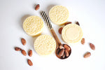 cooca butter lotion bars with cocoa beans on a spoon